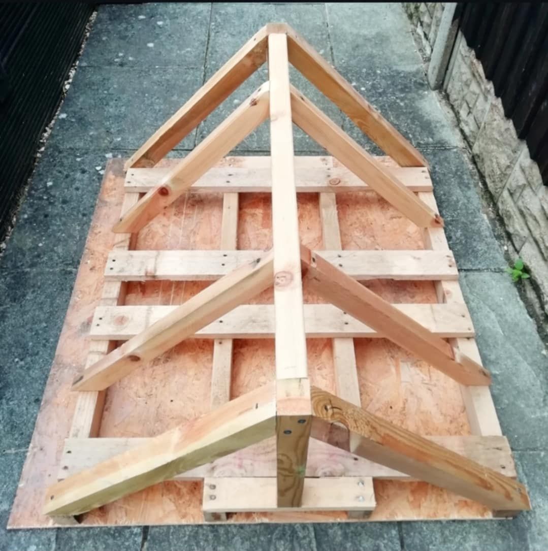 Plain timber frame of the bug hut roof sitting on concrete